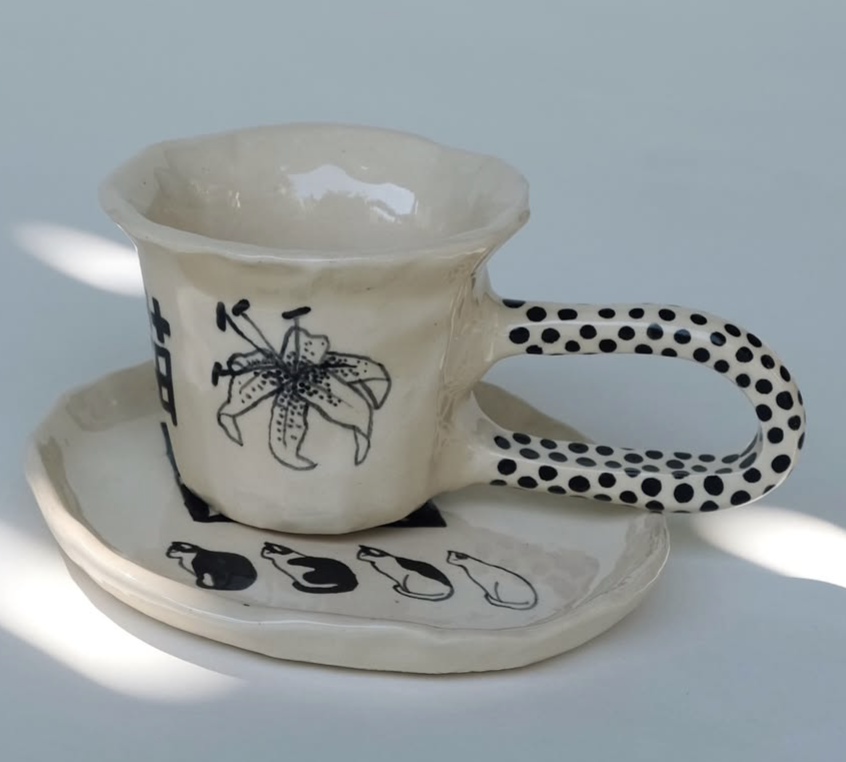 Ceramic cup and saucer with polka-dot handle