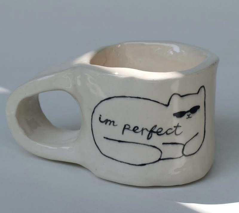Ceramic mug with a cat saying im perfect