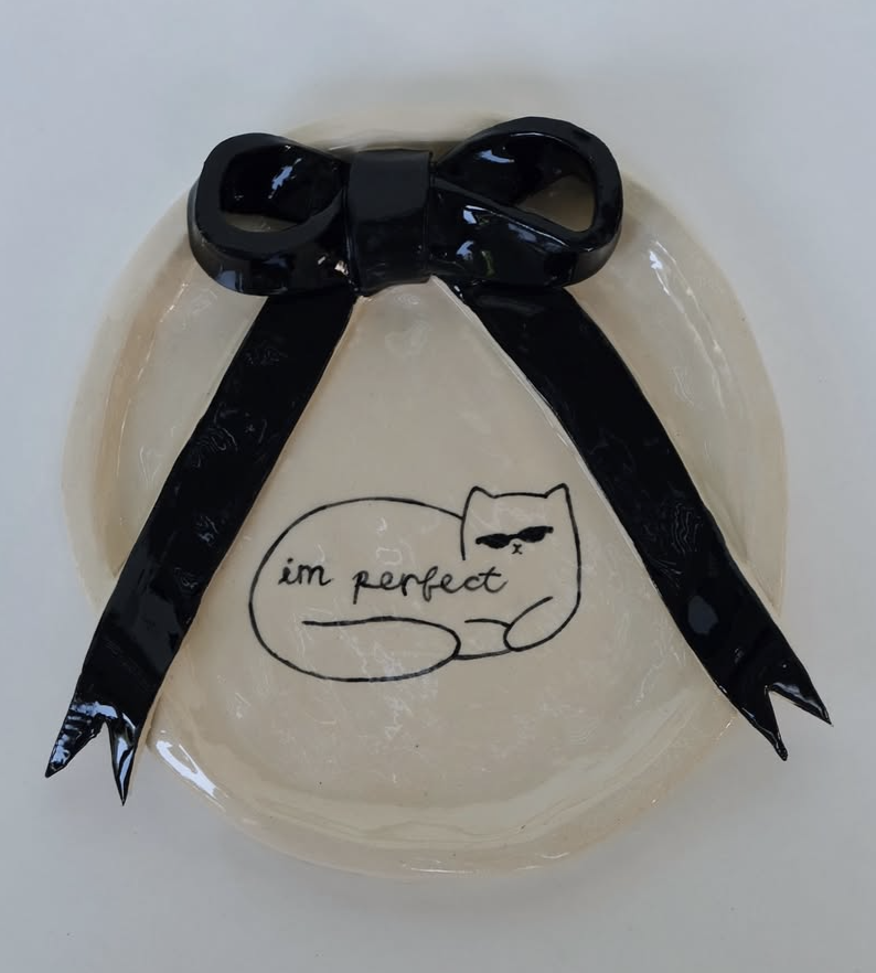 Ceramic plate with black bow and cat drawing