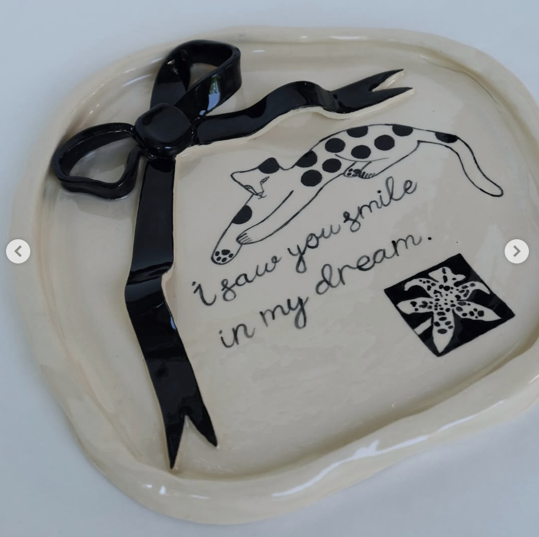 Ceramic tray with black bow, spotted cat, flower, and handwritten text