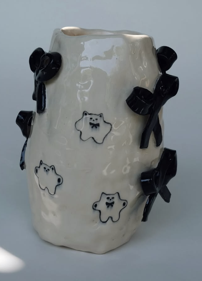 Ceramic vessel with black bows and small bear-cat drawings