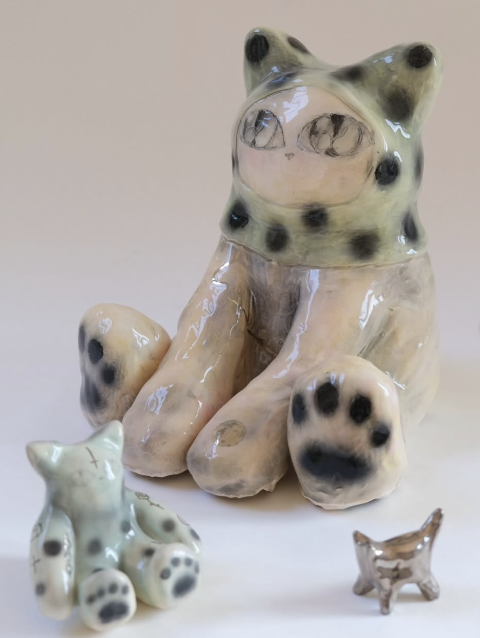 Ceramic cat and small animal figures with spotted details
