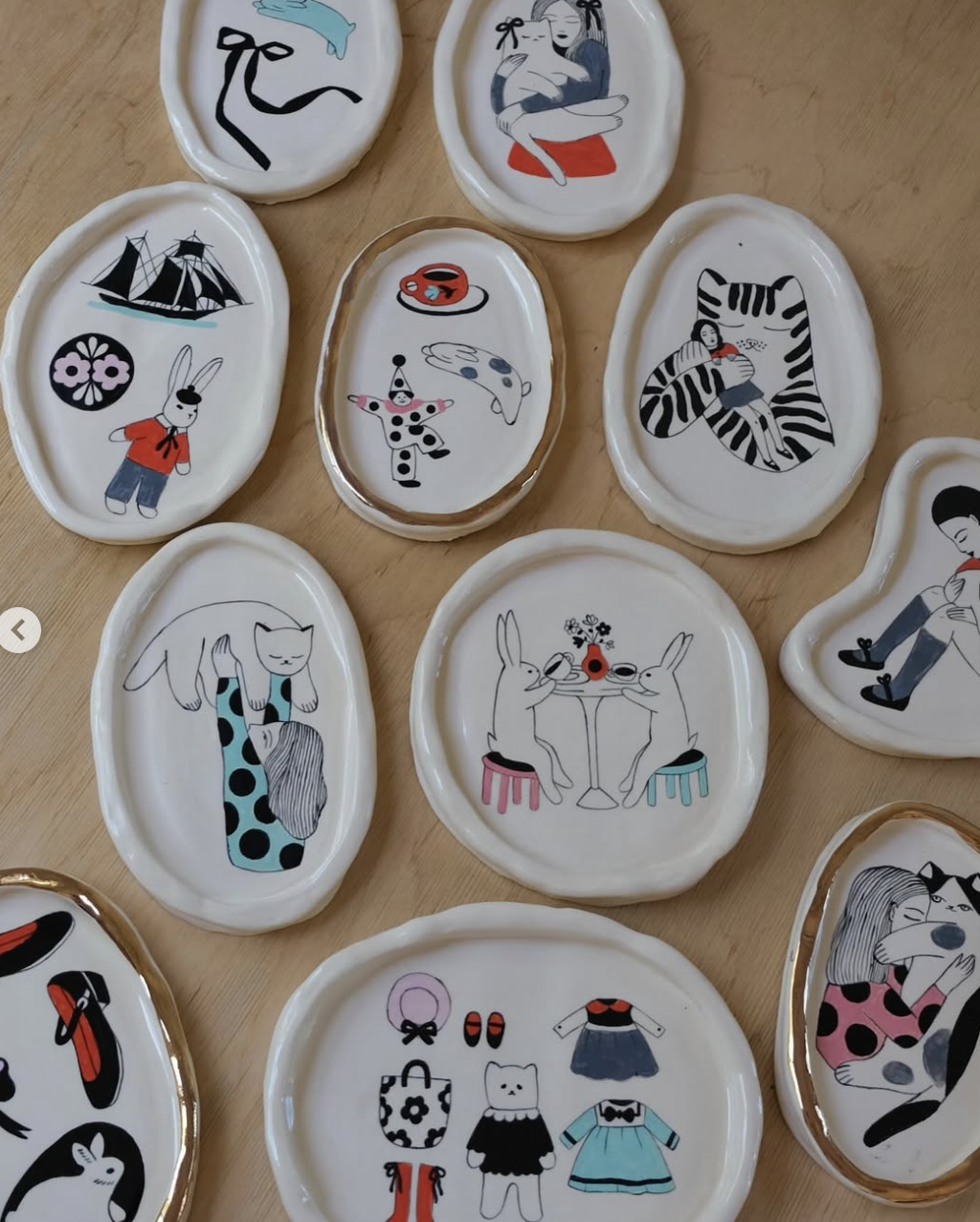 Collection of ceramic plates with illustrated figures and animals