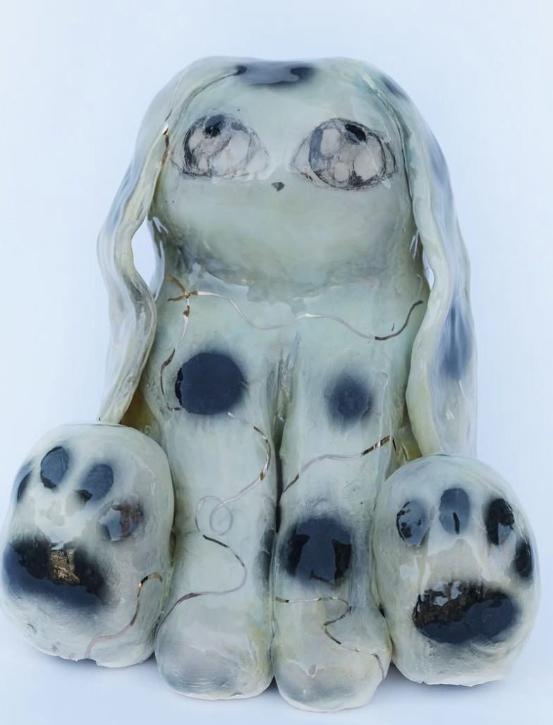 Pale blue ceramic bunny figure with large paws