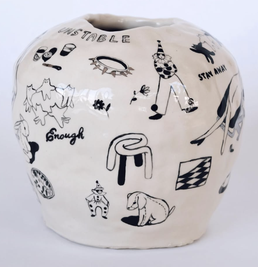 Ceramic vessel painted with black line drawings