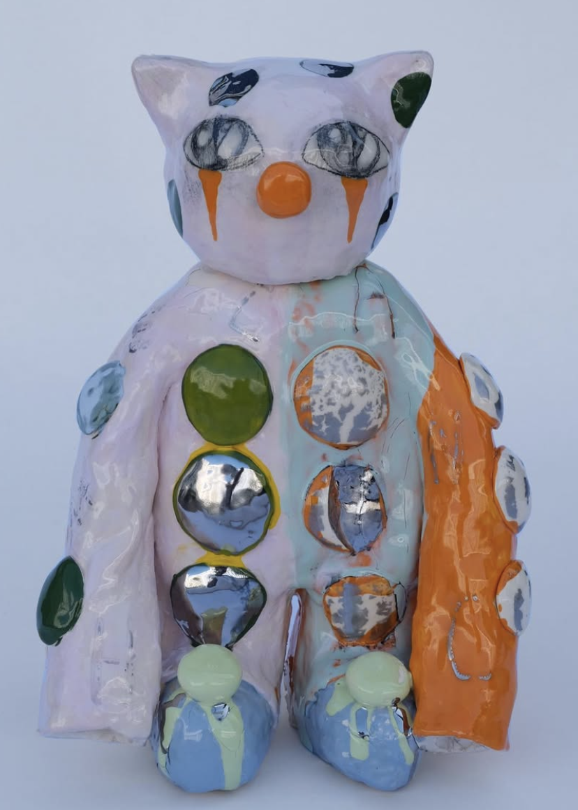 Colorful ceramic cat figure with orange details