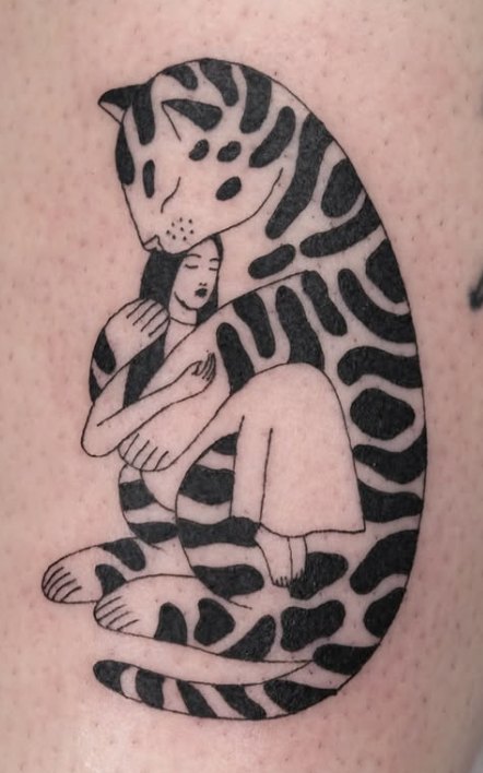Fine-line tattoo of a striped cat curled around a sleeping woman