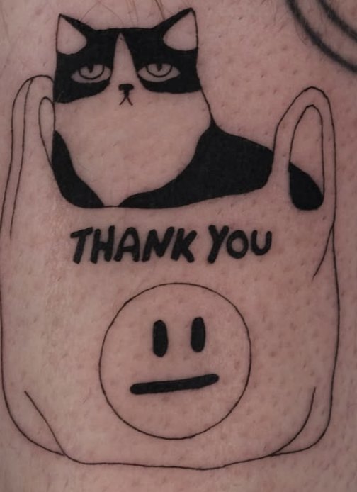 Fine-line tattoo of a tuxedo cat in a Thank You bag