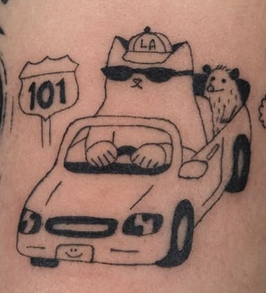 Fine-line tattoo of a cat driving a car with a 101 sign