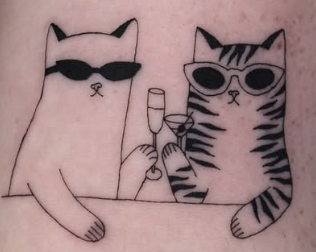 Linework tattoo of two cats in sunglasses sharing drinks