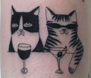 Linework tattoo of two cats with drinks