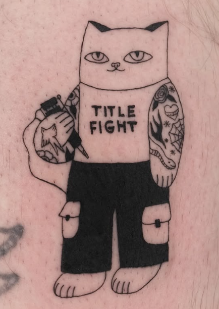 Linework tattoo of a cat tattoo artist wearing Title Fight shorts