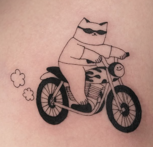 Linework tattoo of a sunglasses cat riding a motorcycle