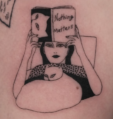 Linework tattoo of a woman reading Nothing Matters with cats