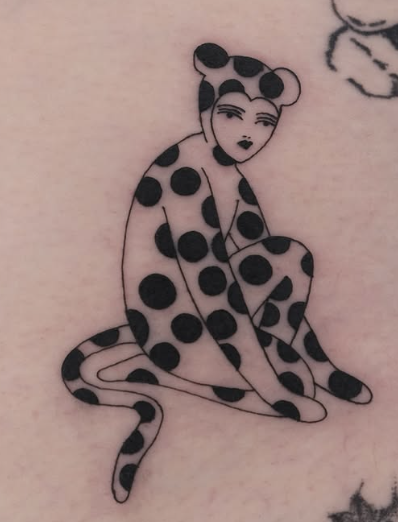 Linework tattoo of a woman in a polka-dot cat suit