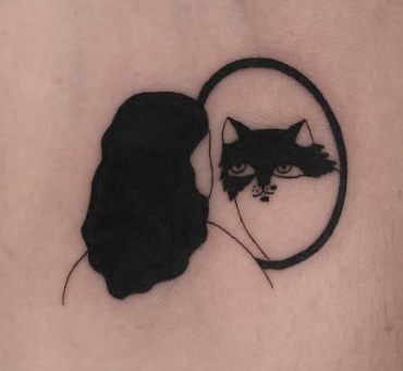 Linework tattoo of a person looking into a mirror with a cat face
