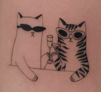 Linework tattoo of two cats with drinks