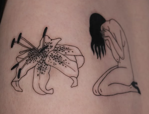 Linework tattoo of a lily beside a seated woman
