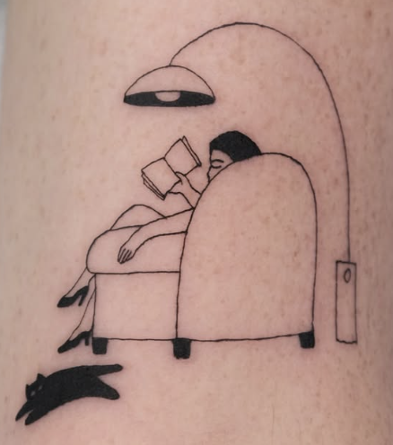 Linework tattoo of a person reading in an armchair with a black cat