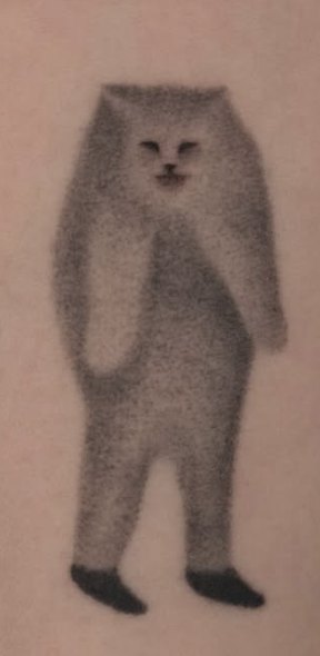 Soft smoky shading tattoo of a standing cat figure