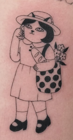Soft shaded tattoo of a cat-girl holding flowers and wearing a polka-dot bag
