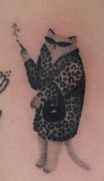 Soft shaded tattoo of a cat in a leopard coat smoking