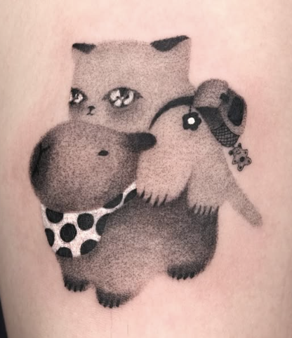 Soft shaded tattoo of a plush cat holding a small toy