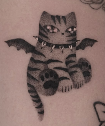 Shaded tattoo of a striped cat with bat wings