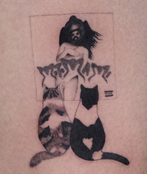 Shaded tattoo of two cats looking at a tattoo poster