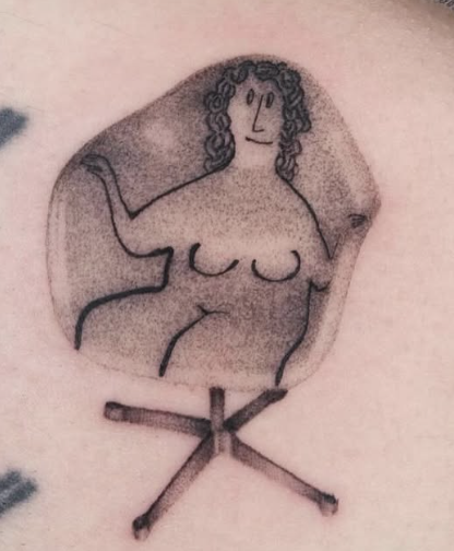 Shaded tattoo of a nude figure sitting in a chair