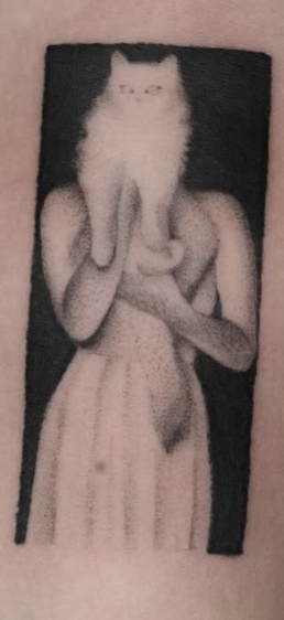 Shaded tattoo of a woman holding a fluffy cat over her face