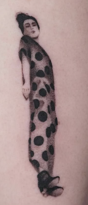 Shaded tattoo of a long figure in a polka-dot suit