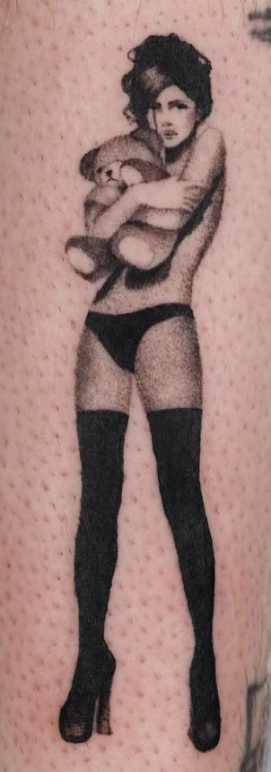 Shaded tattoo of a woman holding a plush rabbit