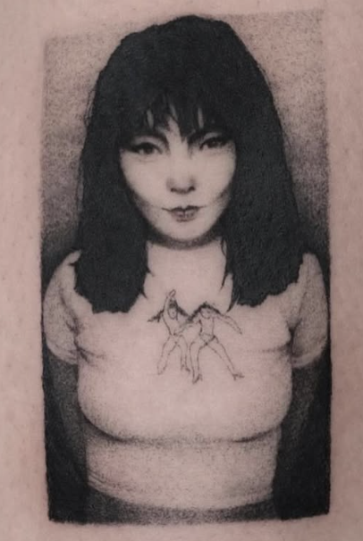 Shaded portrait tattoo of a woman with dark hair